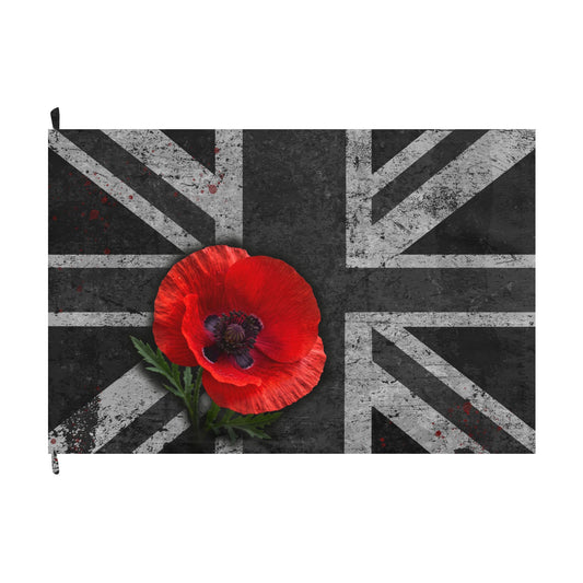 A rectangular zip pouch featuring a distressed Union Jack design in black and white, with a large red poppy flower and green leaves centered over the flag.